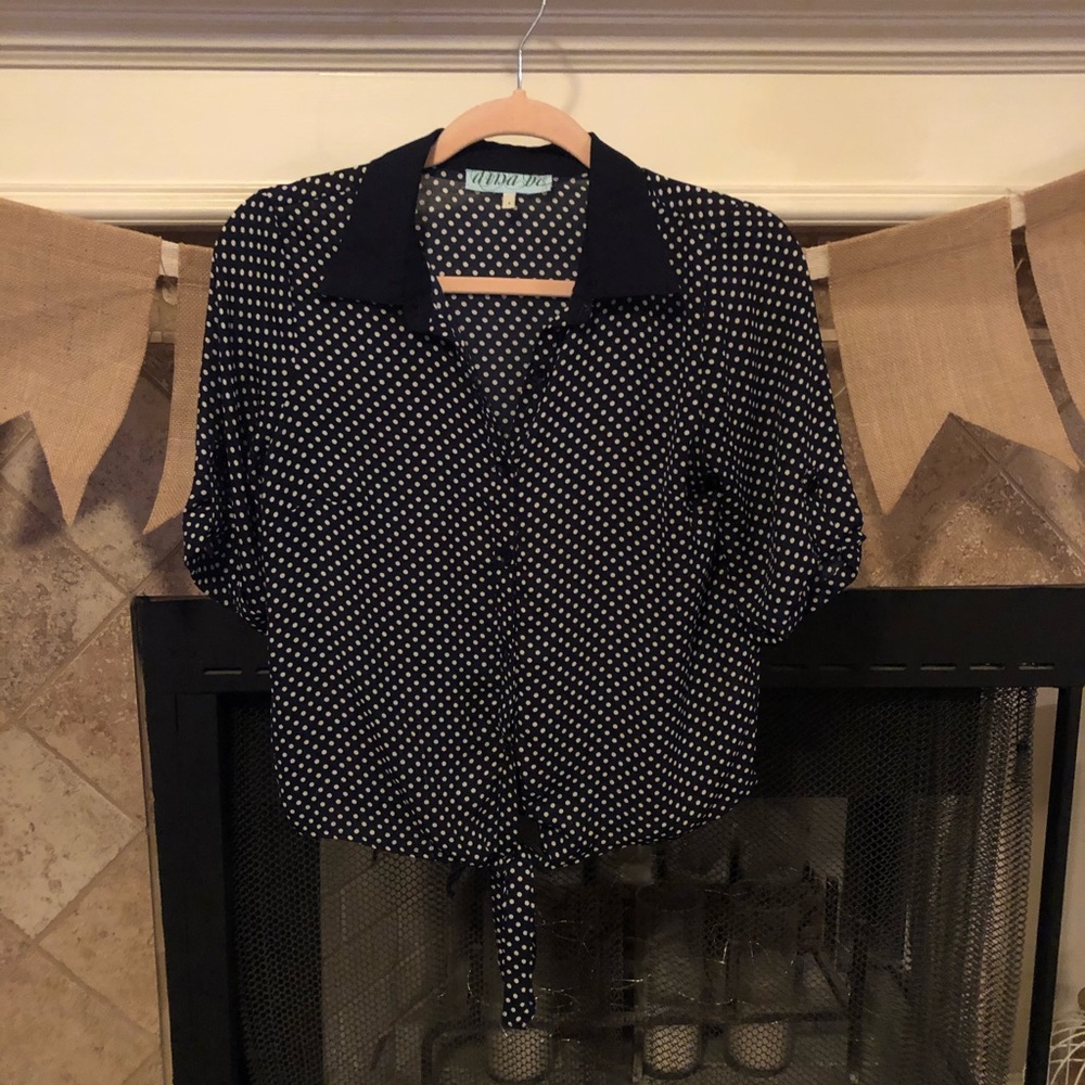 Navy and white polka dot collared top.